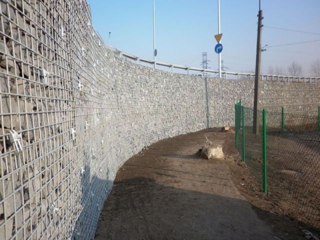 Reinforced soil retaining wall with steel and stone facing.JPG